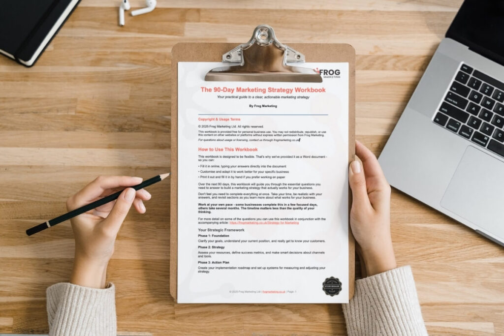 Marketing strategy workbook document, branded by frog marketing and attached to a clipboard - a pen hovering