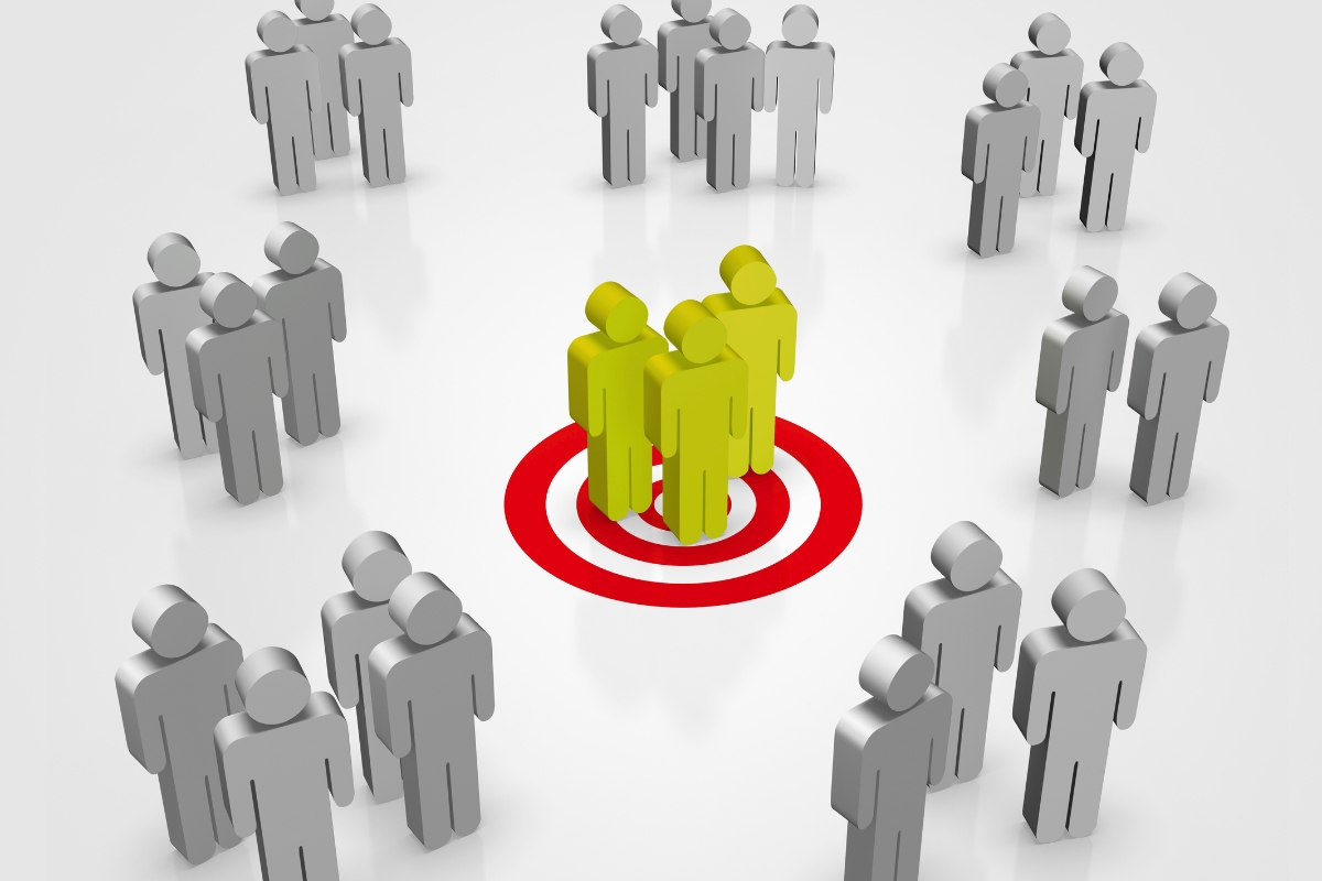 strategy for marketing image depicting the ideal customer, illustrated by groups or stick men with three highlighted in green standing on a bullseye